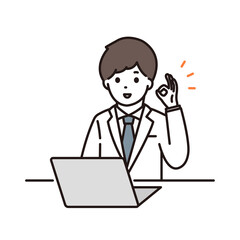 パソコンの前でOKサインをする男性薬剤師
