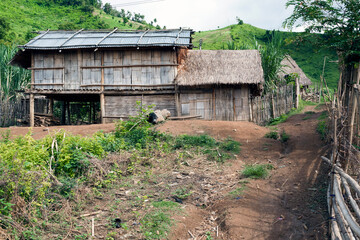 Laos - Hmong hill tribe village, wood hut and metal sheet roof. North of Luang Prabang province. Southeast Asia
