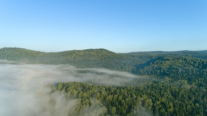 Aerial view: Amazing Sunrise and mist flowing over the mountains , Foggy morning sky with rising...