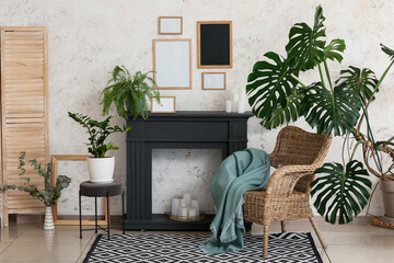 Stylish interior of modern living room with fireplace and houseplants