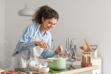 Young woman cooking in kitchen