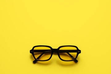 Stylish sunglasses on color background