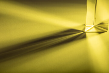 Colorful light play with a prism, made with colored strobe light on white sheet of paper. Painting with yellow light.