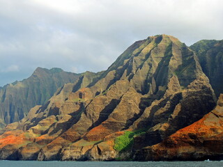 the dramatically-eroded and colorful na pali coast in kauai, hawaii, as seen from  a boat tour
