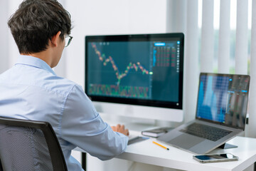 Financial concept a businessman studying the stock chart analyzing the growths of the stock from the chart before investment.