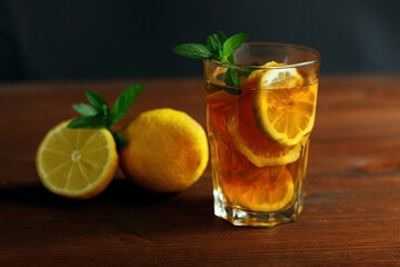 Cold tea with lemon and mint. . A summer drink
