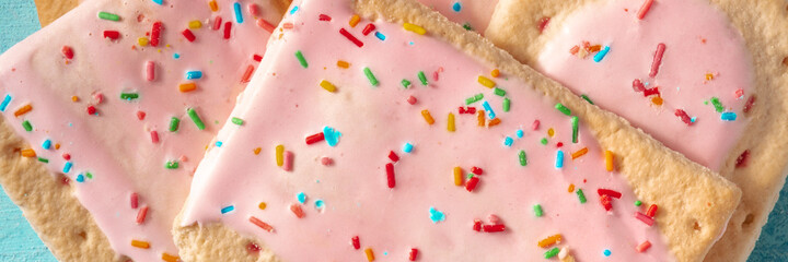 Pop tart panoramic header, a close-up of strawberry toaster pastry, American dessert