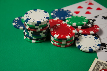 Classic playing cards, chips, red dice and dollars on green background. Gambling and casino concept.
