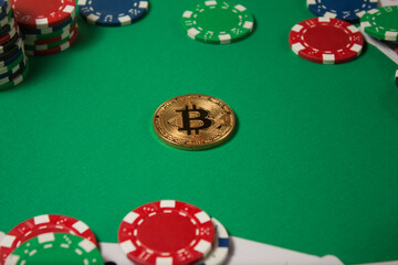 Classic playing cards, chips, red dice, bitcoin and dollars on green background.