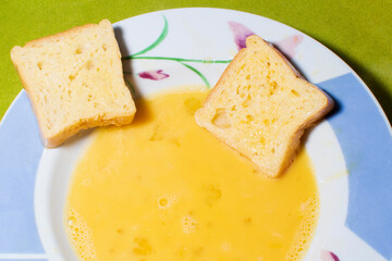 Cooking torrijas, a typical Spanish sweet fried toasts of sliced bread soaked in eggs and wine. Traditional dessert of Holy Week in Spain.