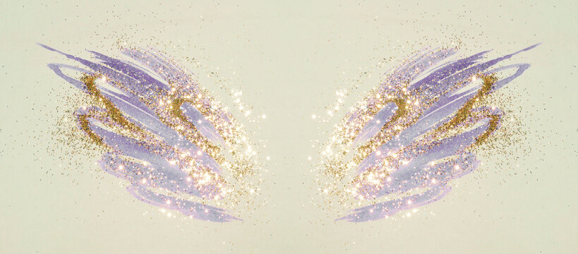 Golden glitter on abstract blue watercolor wings in vintage nostalgic colors