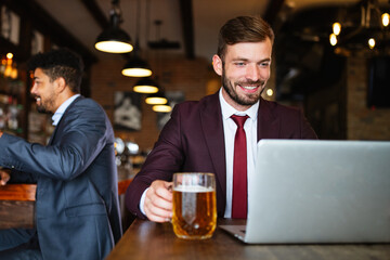 Handsome business man using laptop at his work break in restaurant