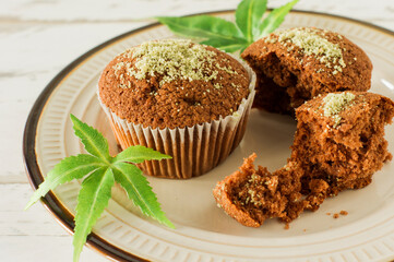 Cupcake with marijuana. Tasty cupcake muffins with cannabis weed cbd. Medical marijuana drugs in food dessert, ganja legalization.
