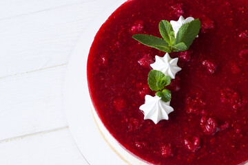 Delicious  strawberry cheesecake decorated mint leaves and  meringue , white background