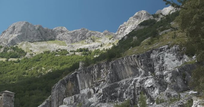 Wall of a white marble quarry under the mountain.The Apuan mountains between the Foce di Giovo and the Passo delle Pecore in Orto di Donna. Apuan Alps, Tuscany, Italy. 