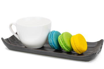 Colorful macaroons on a ceramic tray.