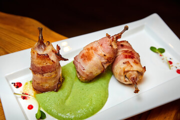 Quail mousse in bacon and broccoli puree. Close-up, selective focus