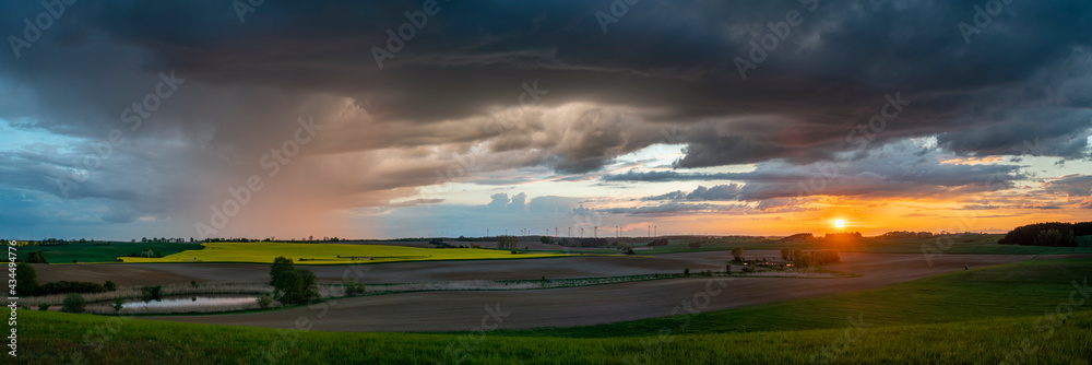 Wall mural evening storm at sunset over the beautiful rural areas