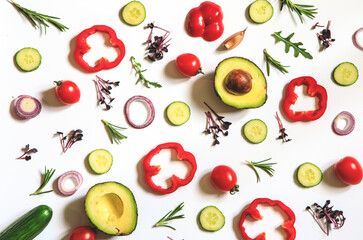 Creative layout of tomatoes, cucumbers, bell peppers, avocados and salads. flat lay. Food concept. place for your text
