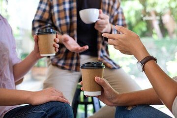 Closeup image of a group of young people enjoyed talking and drinking coffee together