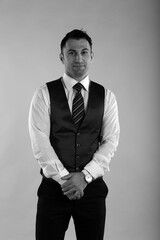 Black and white portrait of a man in white shirt and vest