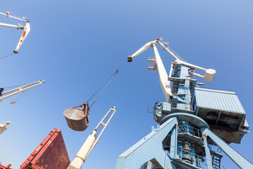 Fototapeta premium Loading and unloading of vessels on industrial terminal 