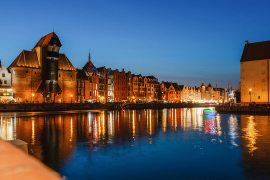 Gdansk night city riverside view. View on famous crane and facades of old medieval houses