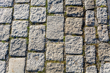 Stone pavement texture. Close up of a granite cobblestoned pavement background. Abstract background of old cobblestone pavement in Vienna, Austria