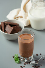 Glass of chocolate milk on the dark background.