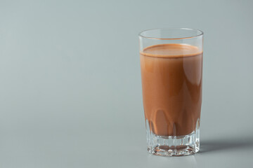 Glass of chocolate milk on the dark background.
