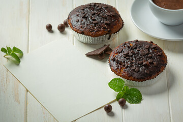 Chocolate muffins on the white wooden background. World Chocolate Day concept