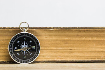 book with compass on table. 