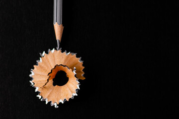 Top shot of a sharpened pencil with the focus point in the centre of the shaving.