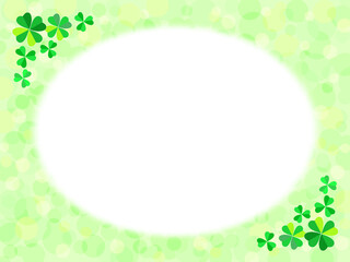 四つ葉と三つ葉のクローバーと緑色のふんわり水玉背景に白い円形のフレーム
