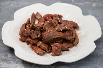fried meat with sauce on white dish