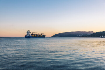 wide river between the mountains at sunset. and a large ship. landscape