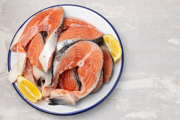 raw salmon with lemon in white dish