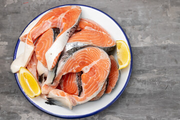 raw salmon with lemon in white dish