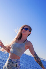 young slander happy woman in short summer cropped top and small shorts by the sea