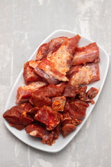 marinated raw meat and ribs on white dish