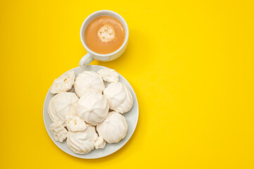 cup of coffee with meringues on white dish