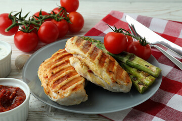 Concept of tasty eating with grilled chicken on white wooden table
