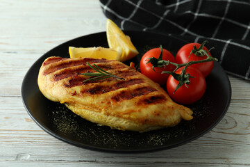 Concept of tasty eating with grilled chicken on white wooden table