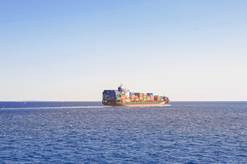 cargo ship transporting containers of goods on the high seas