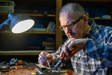 Man repairing an old radio receiver
