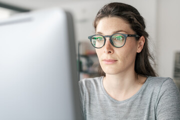 Woman with glasses working on a computer
