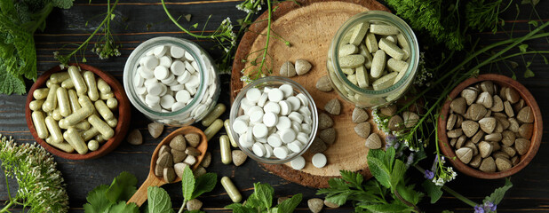 Concept of herbal medicine pills on wooden table, top view - obrazy, fototapety, plakaty