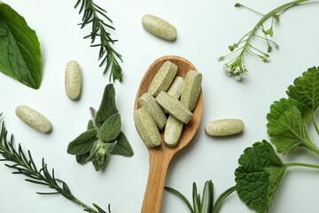 Concept of herbal medicine pills on white background, close up