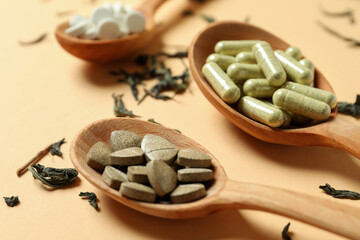 Concept of herbal medicine pills on beige background