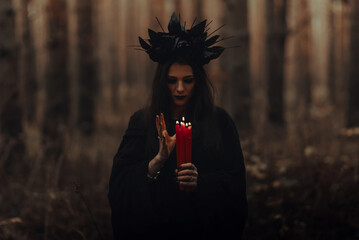 frightening witch performs an occult ritual with candles